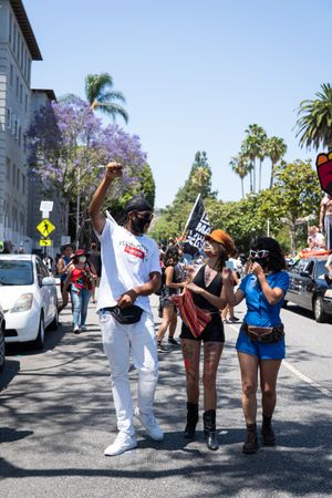 Los Angeles, CA, USA — June 14th, 2020: people walk down city street in Hollywood at protest