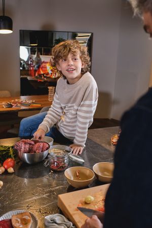 Boy sitting on kitchen counter