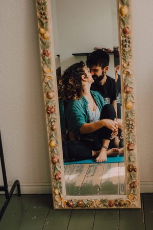 Romantic couple reflecting in rustic mirror