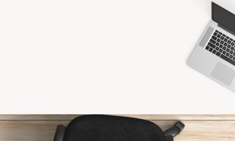 Modern workplace with laptop, coffee cup and notebook copy space on table background. Top view. Flat lay style.