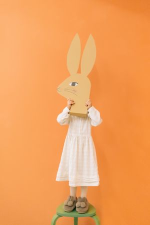 Cute girl holding paper bunny