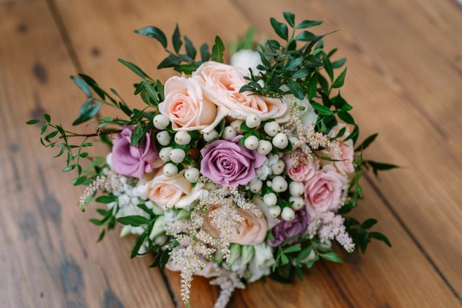 Wedding bouquet with roses on wooden background