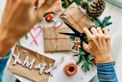 Crop woman wrapping Christmas presents