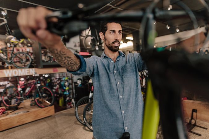 Man at a bicycle showroom looking at bicycles