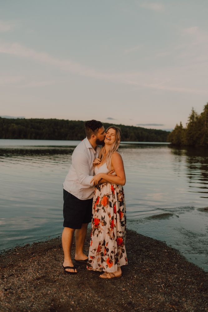 Loving couple standing ankle deep in water on beach