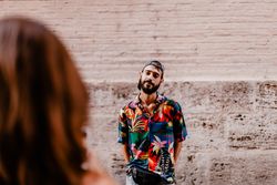 Faceless female taking photo of bearded man