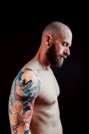 Young shirtless bearded guy with tattoos