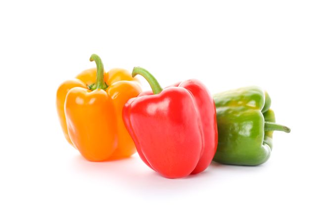 Different bell peppers isolated on plain background