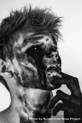 Grayscale portrait of young man with dark face paint bY7MG5