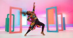 Colorful Geometric Abstract Aesthetic: Portrait of Black Woman Happily Dancing to Energetic Music in a Studio.