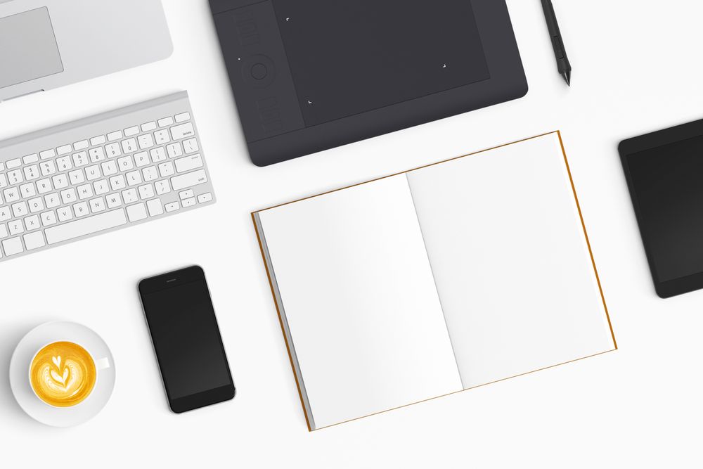Modern workspace with coffee cup, smartphone, paper, notebook and tablet copy space