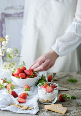 Confectioner cooking dessert of ripe strawberries