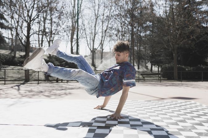 Man dancing break dance in park