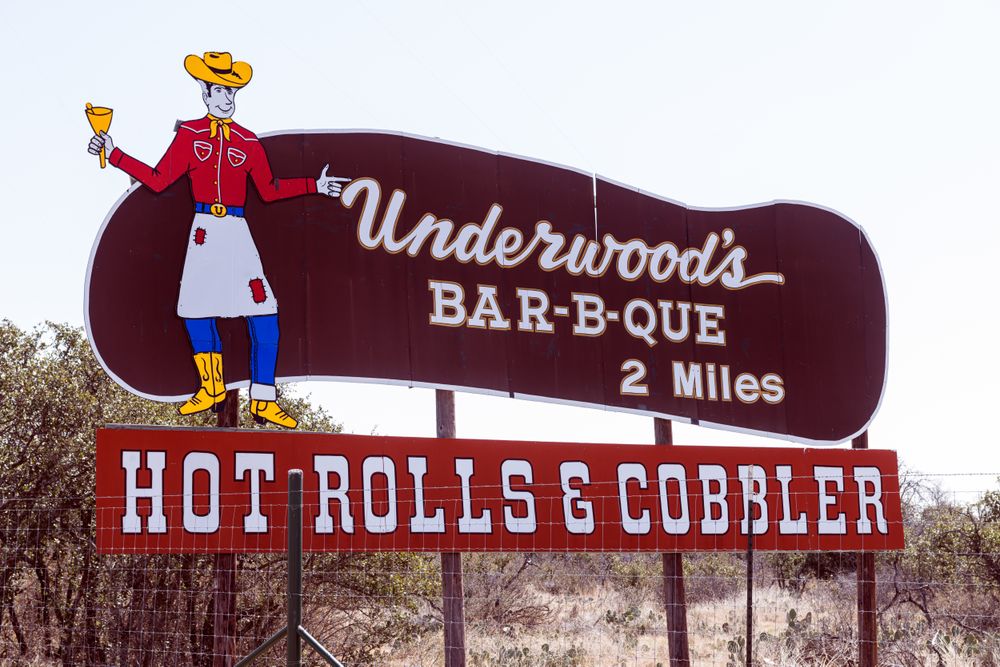 Street sign for a barbecue restaurant in Brownwood, Texas