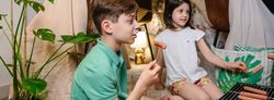 Children grilling and eating sausages on barbecue