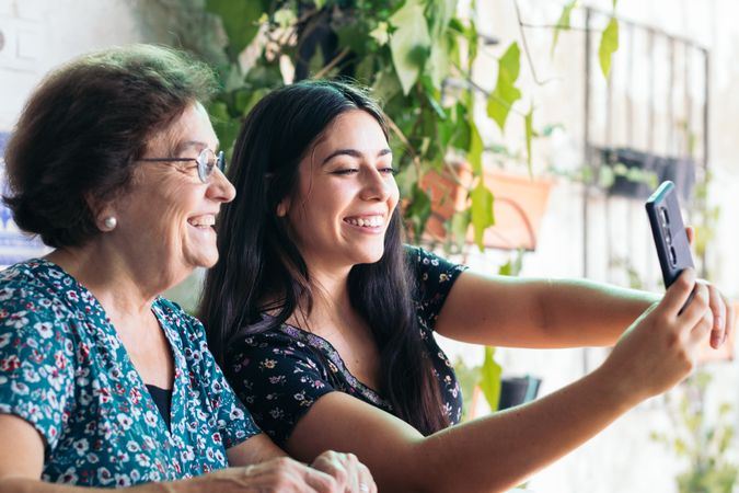 Woman taking selfies with her grandmother