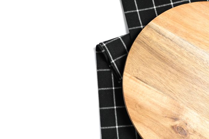 Cutting board with kitchen towel isolated on plain background, top view