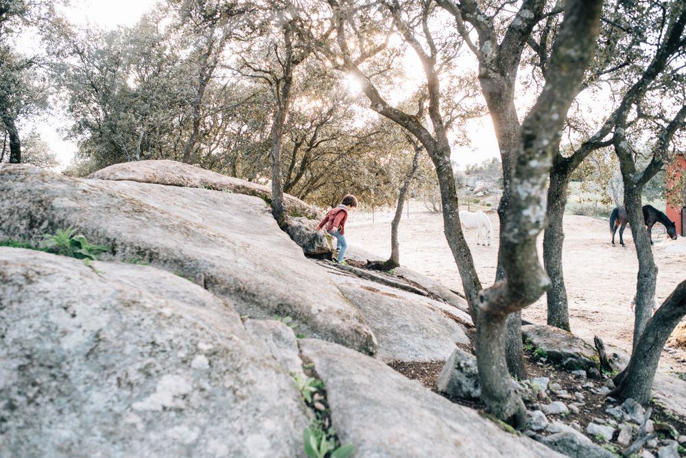 Boy walking on rocky hill