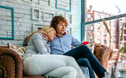 Couple hugging on a sofa