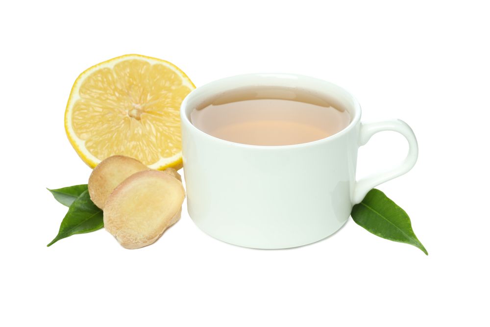 Cup of tea, ginger and lemon slices, isolated on plain background