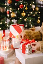 Cropped image of a person wrapping Christmas gift box bEXl64