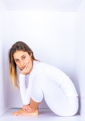 Woman wearing white posing in box