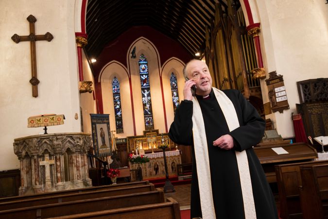 Vicar taking call