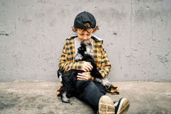 Little boy with purebred dog on street