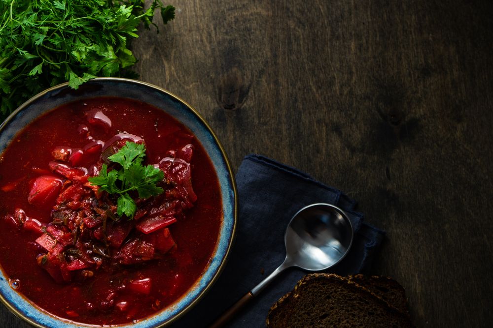 Ukrainian beetroot soup borscht on wooden table