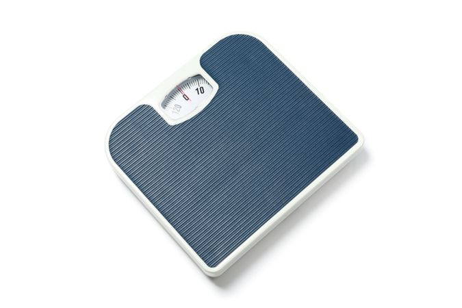 Blue weigh scales isolated on plain background