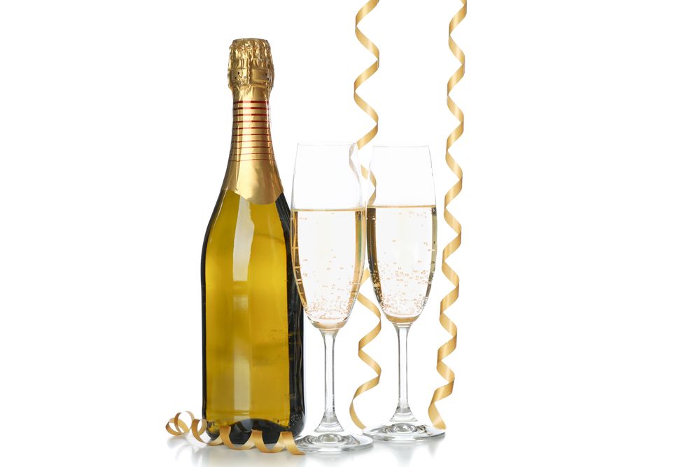 Champagne glasses, bottle and ribbons isolated on light background