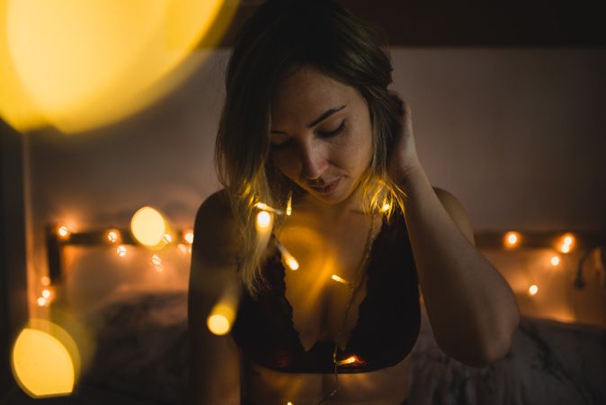 Woman surrounded with light garland