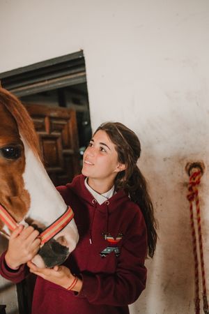 Girl with adorable pony in hat