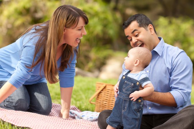 Happy Young Family Playing In The Park