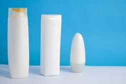 Variety of mockup cosmetic bottles in blue room