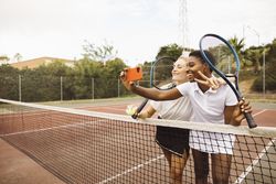 Portrait of two young women on a tennis court