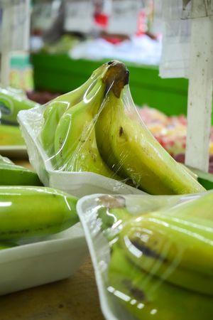 Banana fruits wrapped and for sale in grocery store