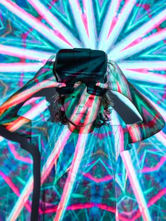 Boy with VR headset under bright projector light