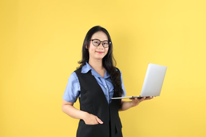 Asian Business Woman with Casual Fashion Wearing Glasses, Holding Laptop