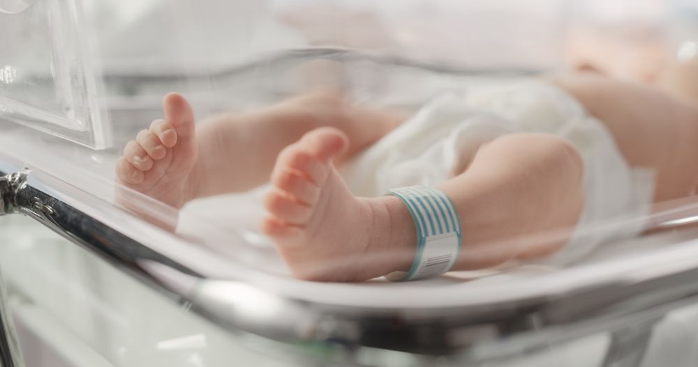 Cute Little Newborn Baby Lying in Bassinet in a Maternity Hospital.