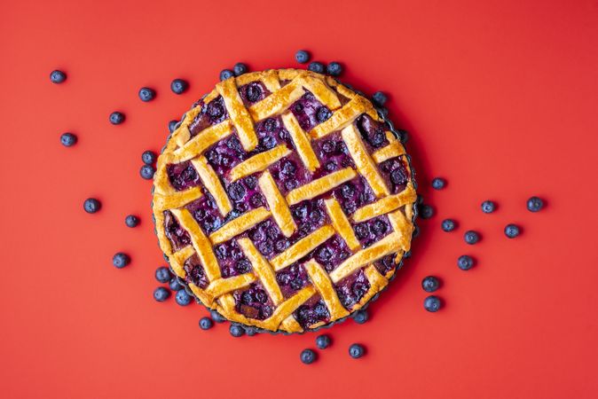 Traditional blueberry pie on red background