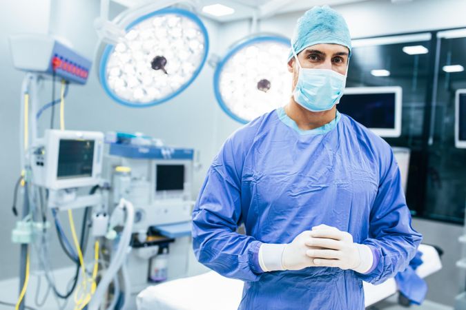 Portrait of male surgeon in operation theater looking at camera