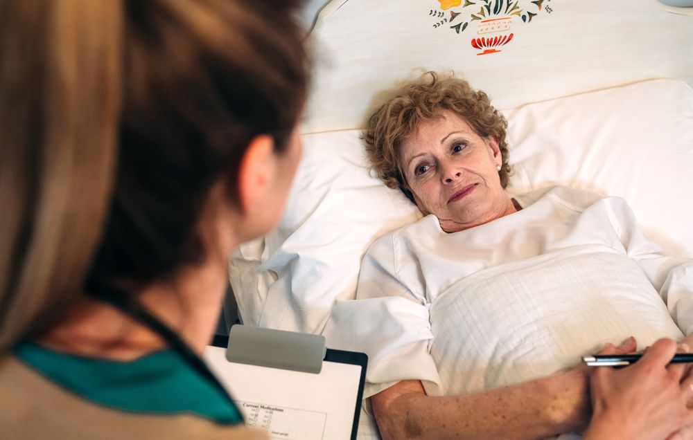 Female doctor comforting older patient