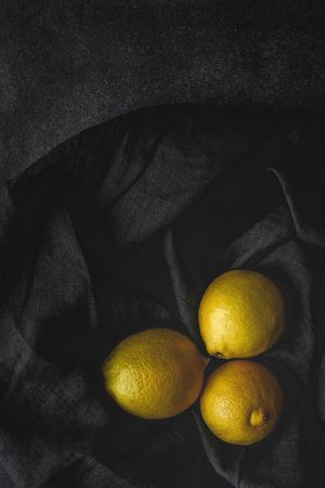 Fresh lemons on dark background.