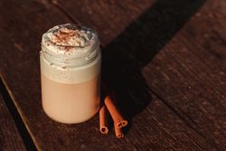 Cinnamon near coffee on table