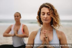 Fitness women doing yoga at the beach on a cloudy morning bY1PDb