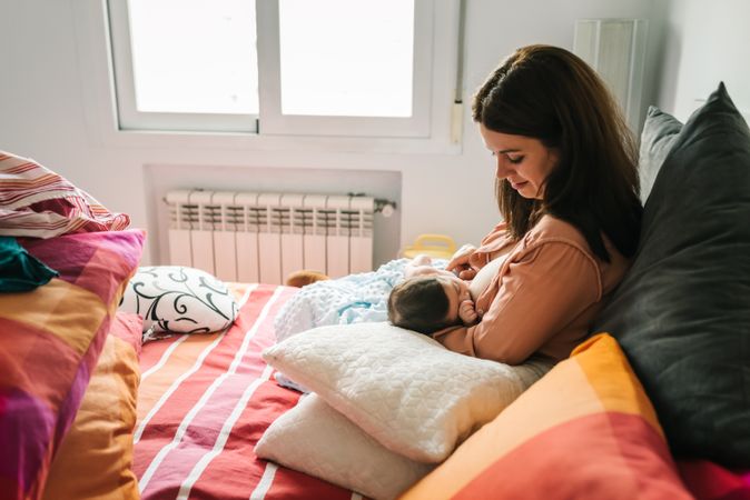 Mom breastfeeding at home