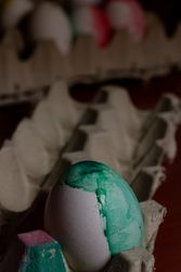 Painted Easter egg in container on table