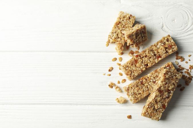 Tasty granola bars on wooden background