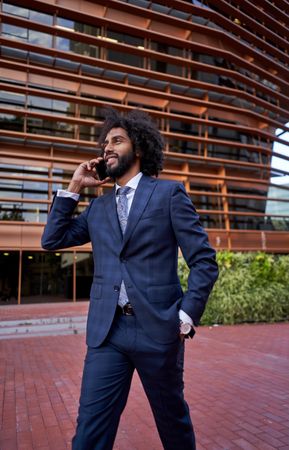 smiling businessman talking on smartphone